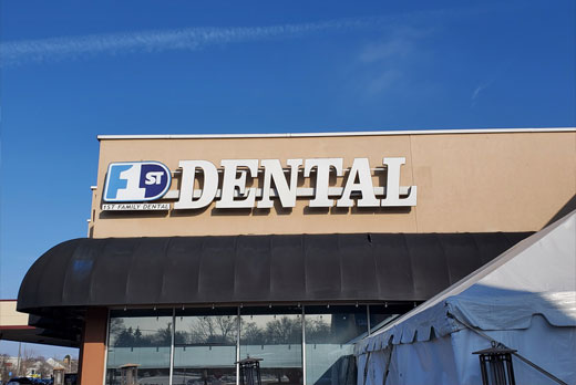 Family Dental Backlit Sign in glowing neon signage style