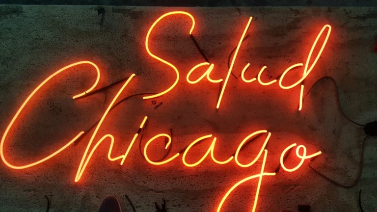 Neon sign featuring salud chicago script neon sign