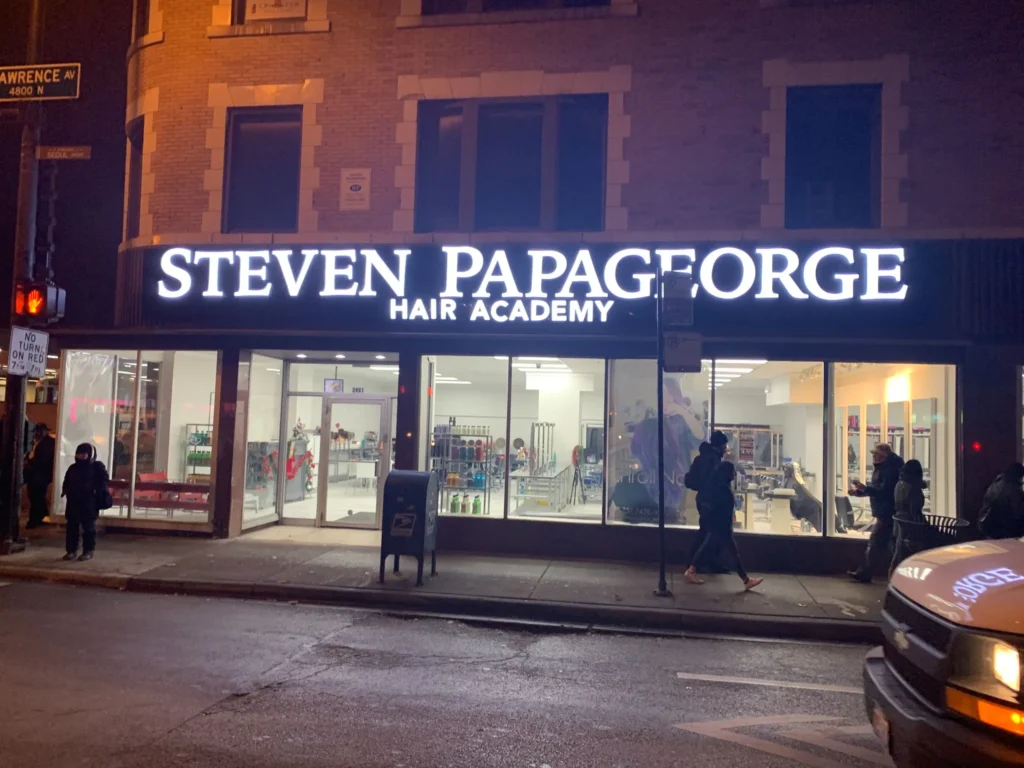 Neon sign featuring steven papageorge academy lighted sign